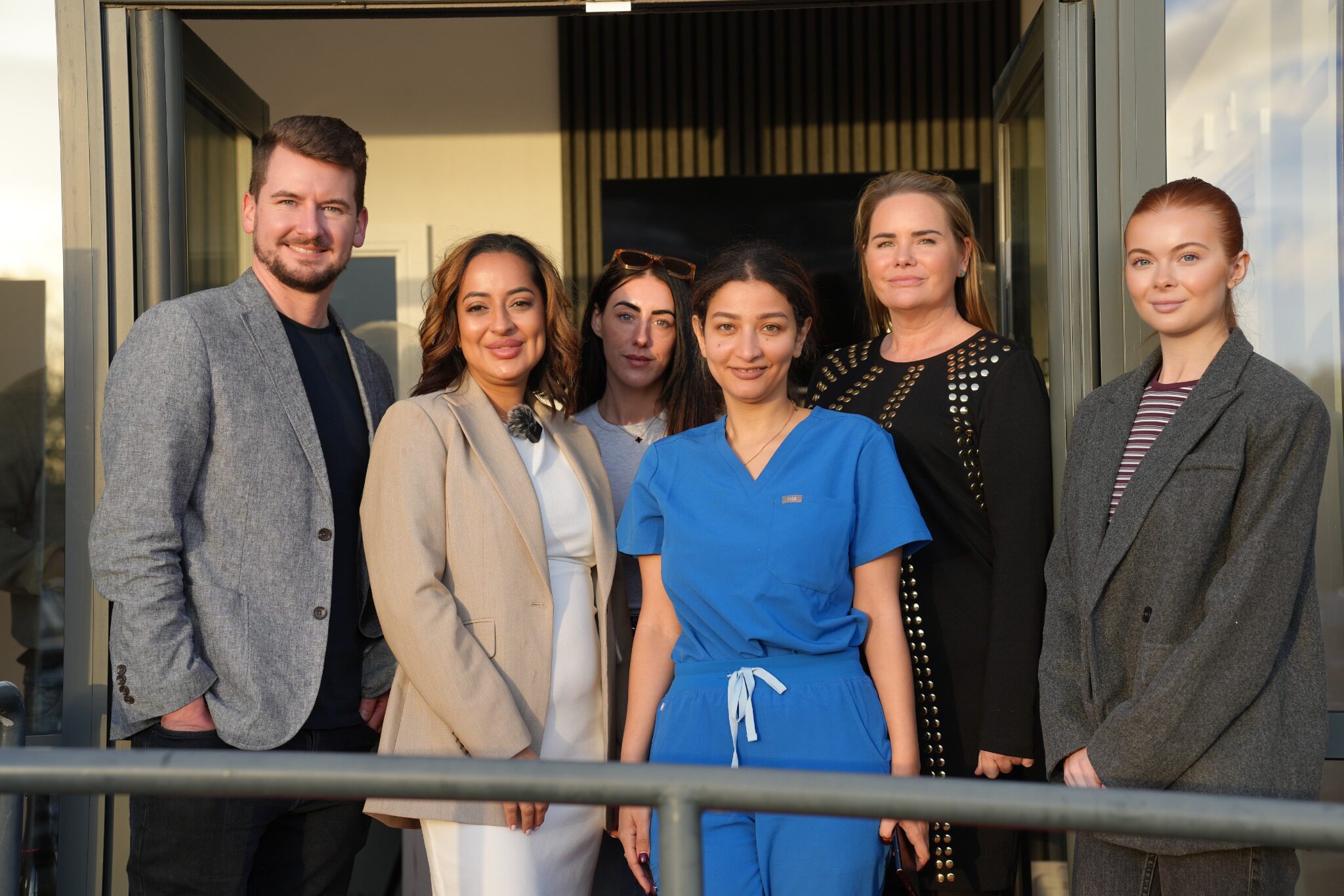 Dr Keiron Lord and the Revive NX team standing together outside the new waterfront clinic in Leigh, Greater Manchester, during the national Regenerative Aesthetics Roadshow.