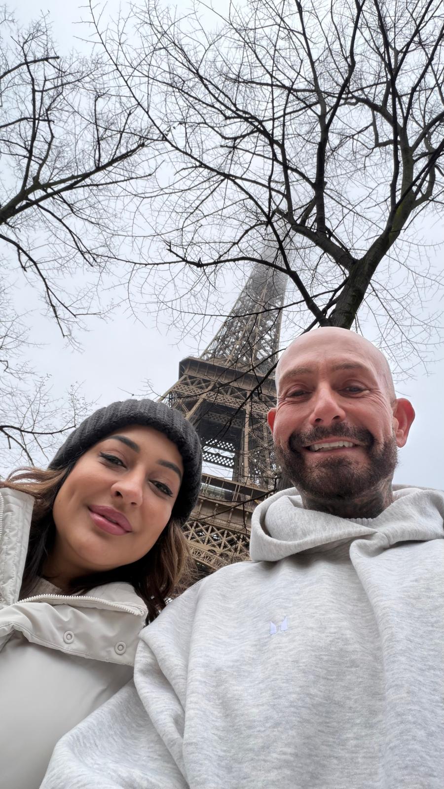 Nita McEvoy and Steven Lewis Barrett at the Eiffel Tower in Paris during IMCAS Paris 2026