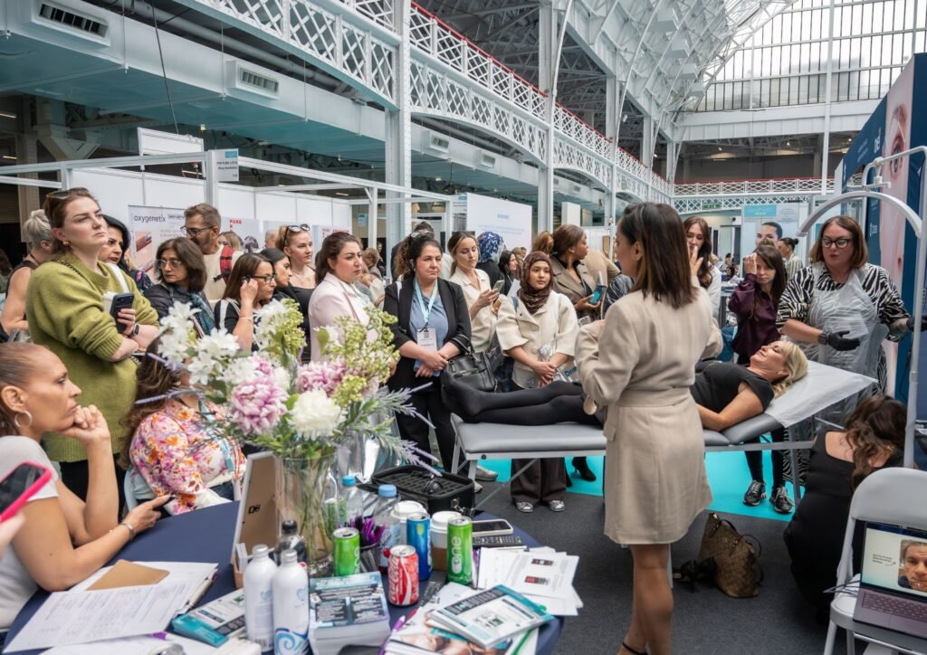 Packed Revive NX stand talk at Aesthetic Medicine Live 2026 discussing regenerative aesthetics, Korean biotech, longevity medicine, exosomes, microneedling and undetectable injectables led by CEO Nita McEvoy.